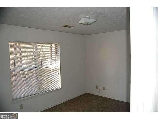 771 Farm Creek Road Northeast Woodstock, GA 30188 - Photo 14 of 14 a view of an empty room with a window