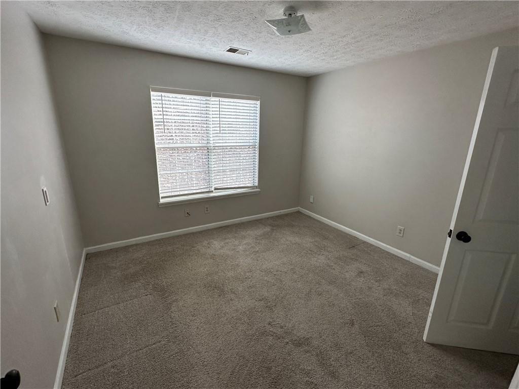 771 Farm Creek Road Northeast Woodstock, GA 30188 - Photo 3 of 14 an empty room with a window