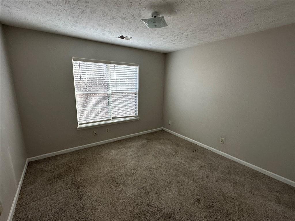 771 Farm Creek Road Northeast Woodstock, GA 30188 - Photo 4 of 14 an empty room with a window