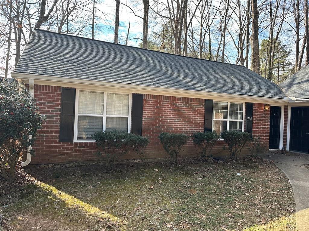 771 Farm Creek Road Northeast Woodstock, GA 30188 - Photo 5 of 14 a front view of house with yard and seating space