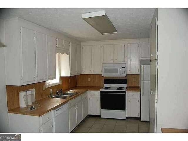 771 Farm Creek Road Northeast Woodstock, GA 30188 - Photo 10 of 14 a kitchen with stainless steel appliances granite countertop a stove a sink and a refrigerator