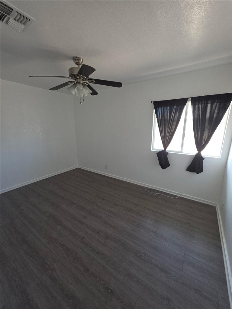 512 E Street Needles, CA 92363 - Photo 13 of 20 an empty room with wooden floor and windows