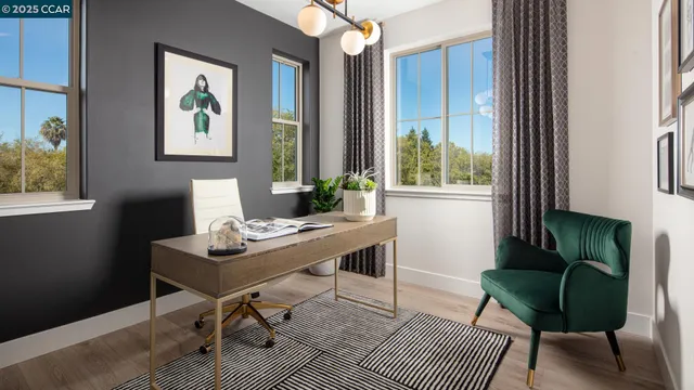 a view of a workspace with furniture and a window