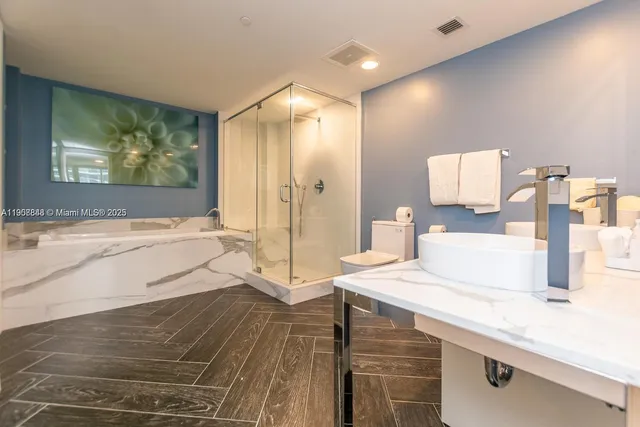 a spacious bathroom with a sink toilet and shower