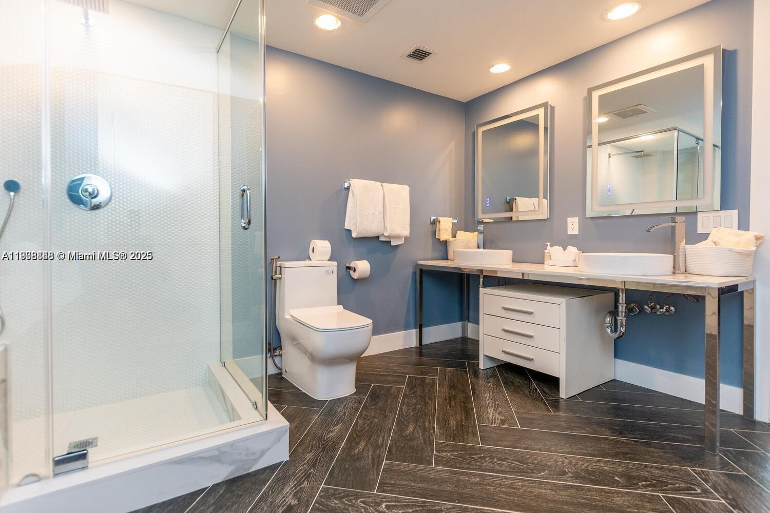 485 Brickell Avenue, Unit 2302 Miami, FL 33131 - Photo 7 of 20 a spacious bathroom with a sink toilet and shower