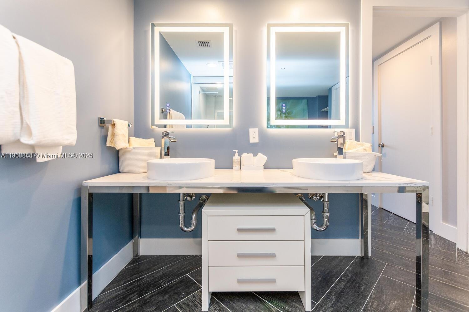 485 Brickell Avenue, Unit 2302 Miami, FL 33131 - Photo 8 of 20 a bathroom with a sink and a mirror