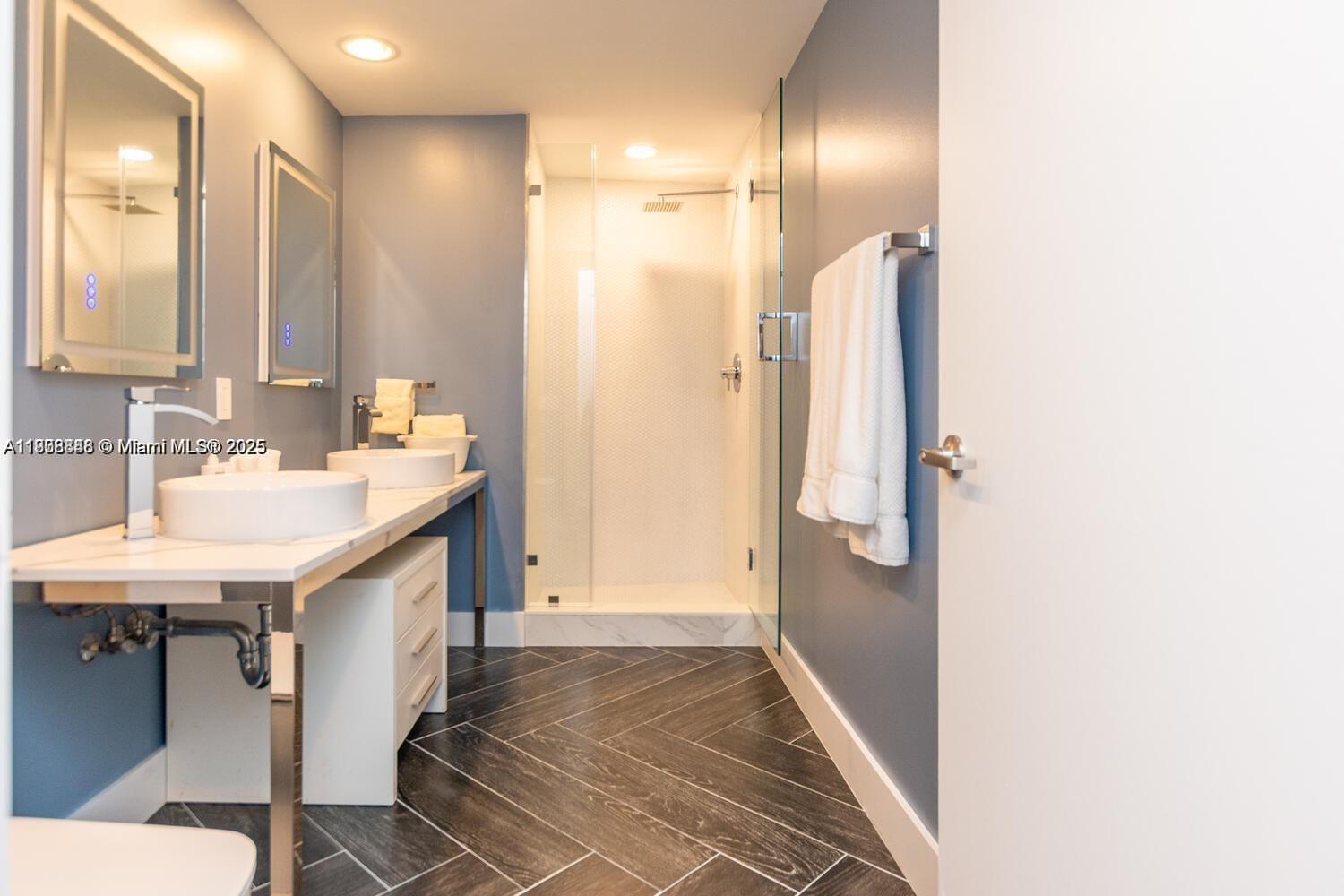 485 Brickell Avenue, Unit 2302 Miami, FL 33131 - Photo 9 of 20 a bathroom with a sink and a mirror