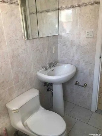 a bathroom with a sink toilet and a mirror