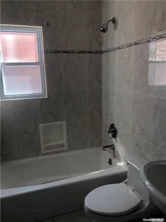 a bathroom with a bathtub and window