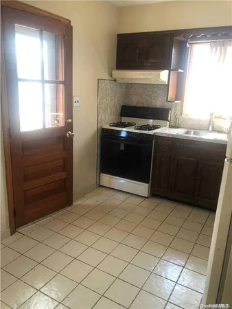 a kitchen with a cabinets and a stove top oven