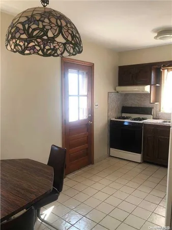 a kitchen with a refrigerator and a stove top oven