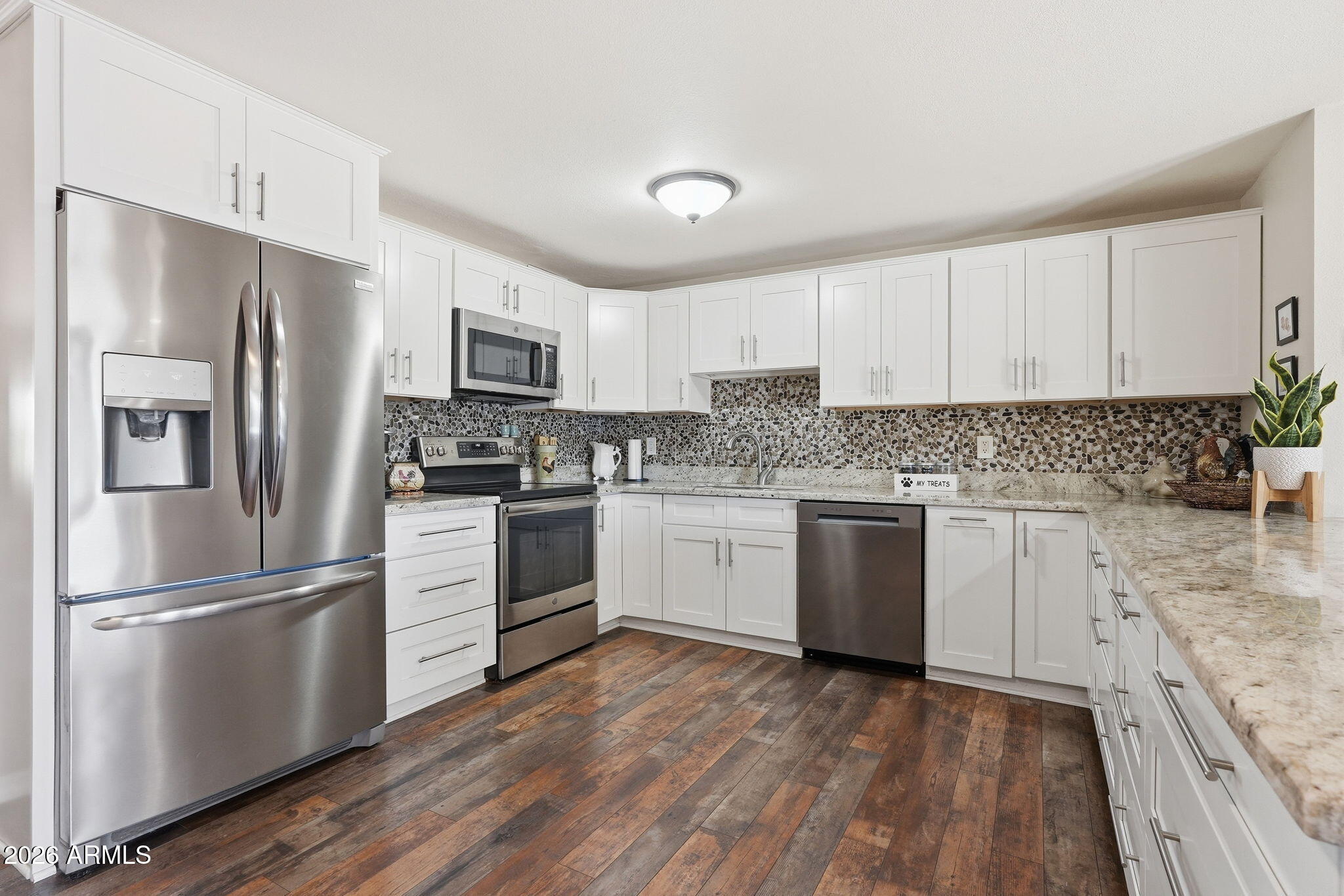 3765 East Pershing Avenue Phoenix, AZ 85032 - Photo 10 of 48 a kitchen with granite countertop white cabinets and stainless steel appliances