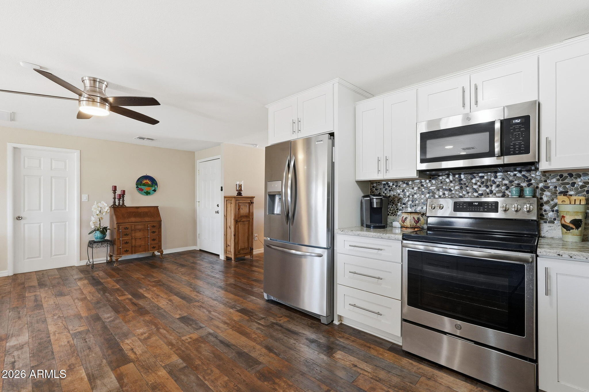 3765 East Pershing Avenue Phoenix, AZ 85032 - Photo 11 of 48 a kitchen with granite countertop a refrigerator stove and microwave