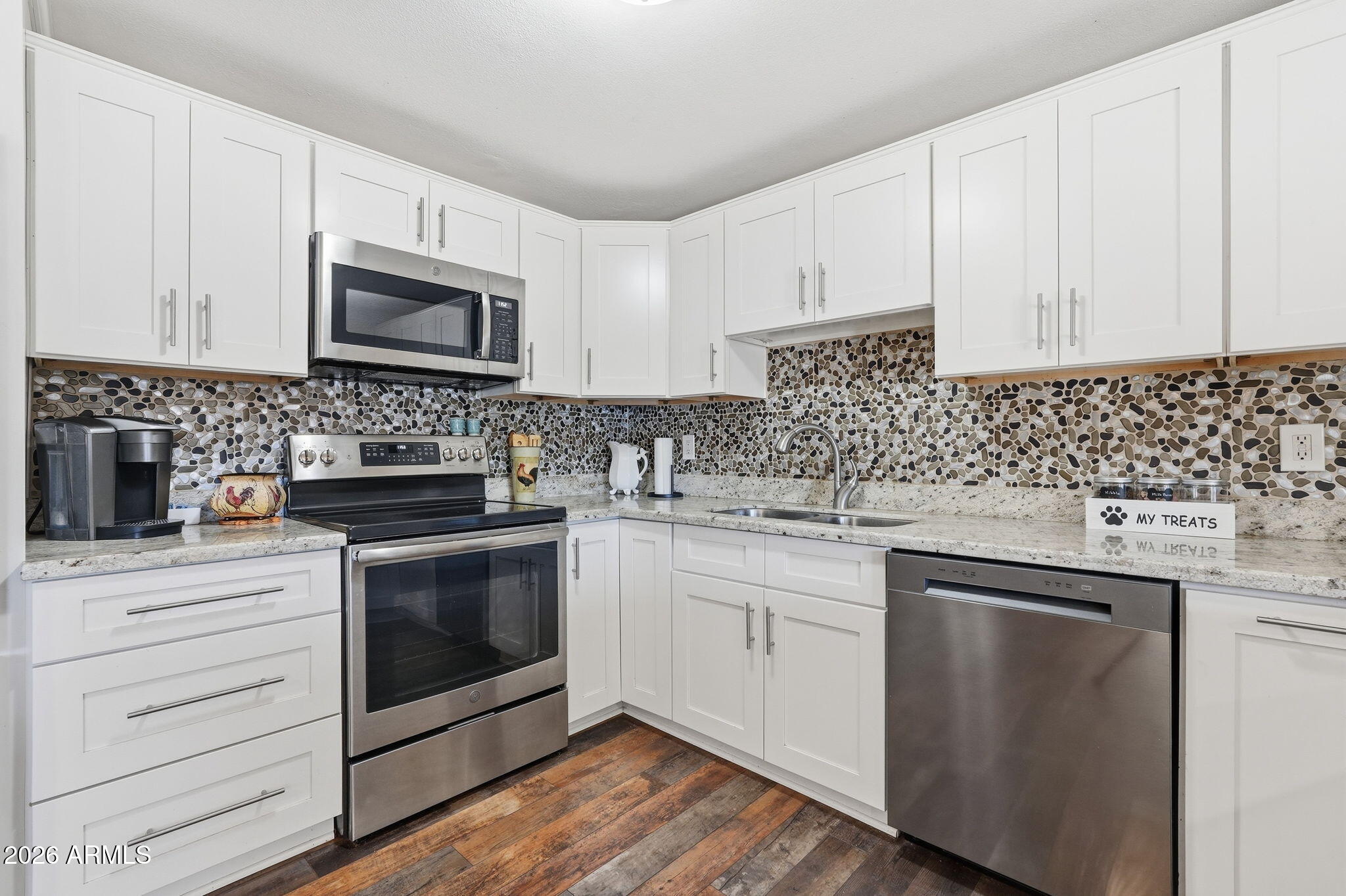 3765 East Pershing Avenue Phoenix, AZ 85032 - Photo 12 of 48 a kitchen with white cabinets stainless steel appliances and sink