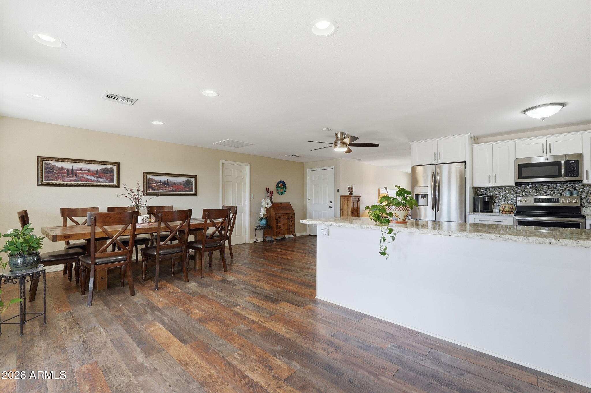 3765 East Pershing Avenue Phoenix, AZ 85032 - Photo 17 of 48 a view of a dining room with furniture window and wooden floor