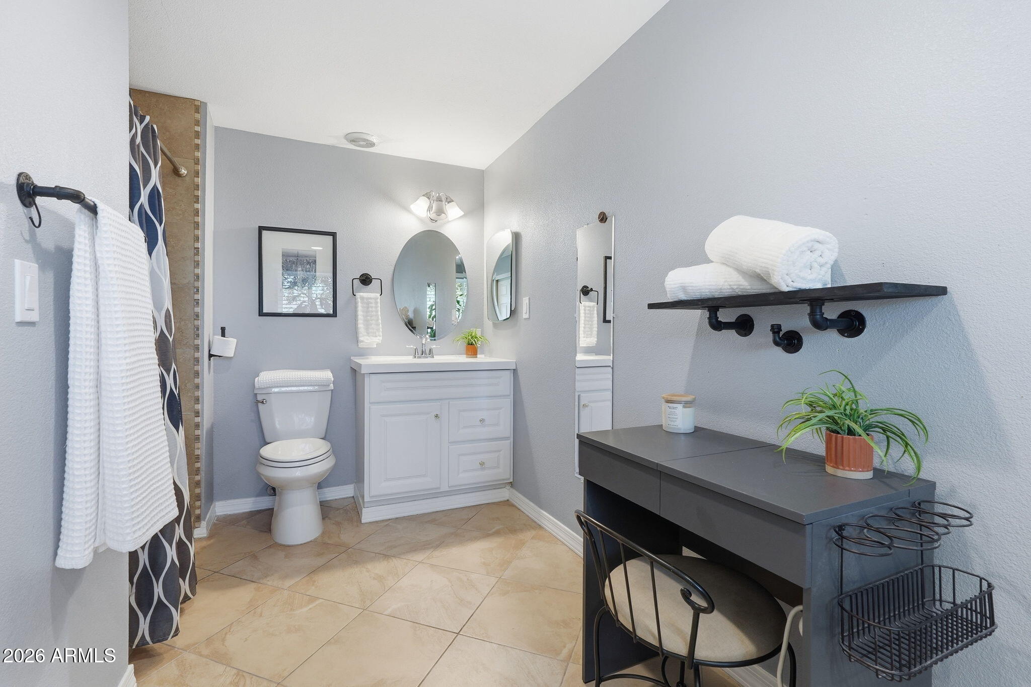 3765 East Pershing Avenue Phoenix, AZ 85032 - Photo 26 of 48 a bathroom with a sink toilet and a mirror