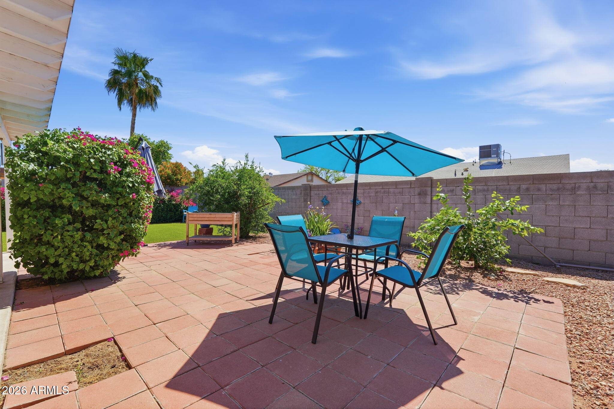 3765 East Pershing Avenue Phoenix, AZ 85032 - Photo 32 of 48 a patio with a patio table and chairs