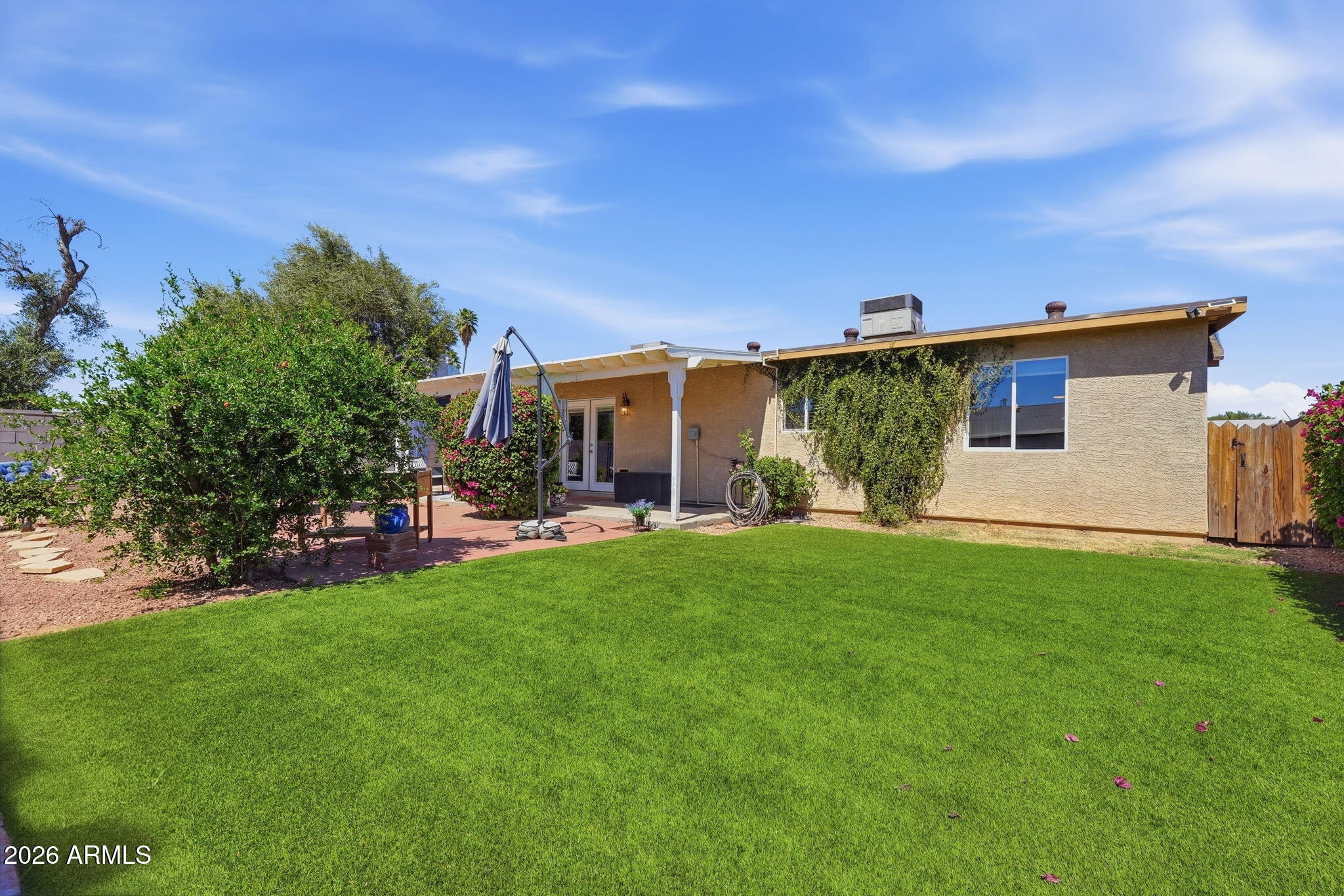 3765 East Pershing Avenue Phoenix, AZ 85032 - Photo 35 of 48 a front view of a house with garden