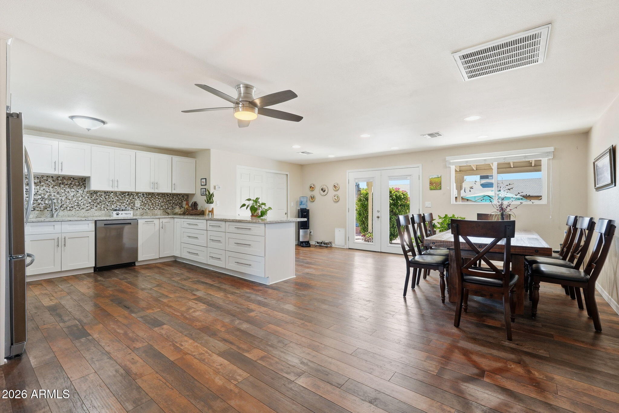 3765 East Pershing Avenue Phoenix, AZ 85032 - Photo 8 of 48 a view of a dining room with furniture and wooden floor