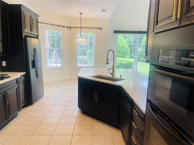 a view of kitchen with kitchen island and stainless steel appliances