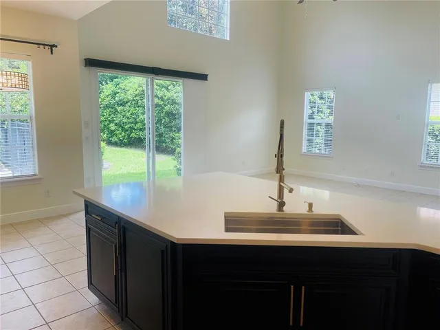 a view of kitchen with kitchen island and stainless steel appliances