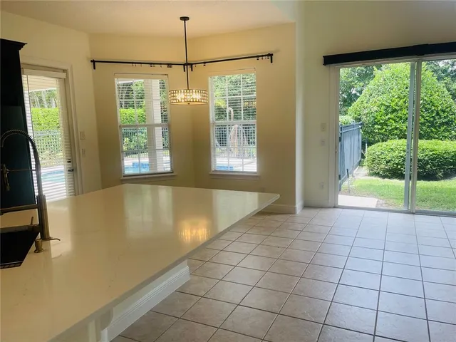 a view of staircase with wooden floor and a front door