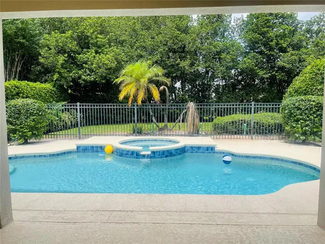 a view of a backyard with swimming pool