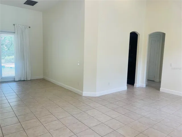 a view of a room with an empty space and a window