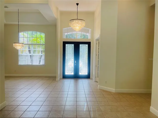 an empty room with a flat screen tv and a window