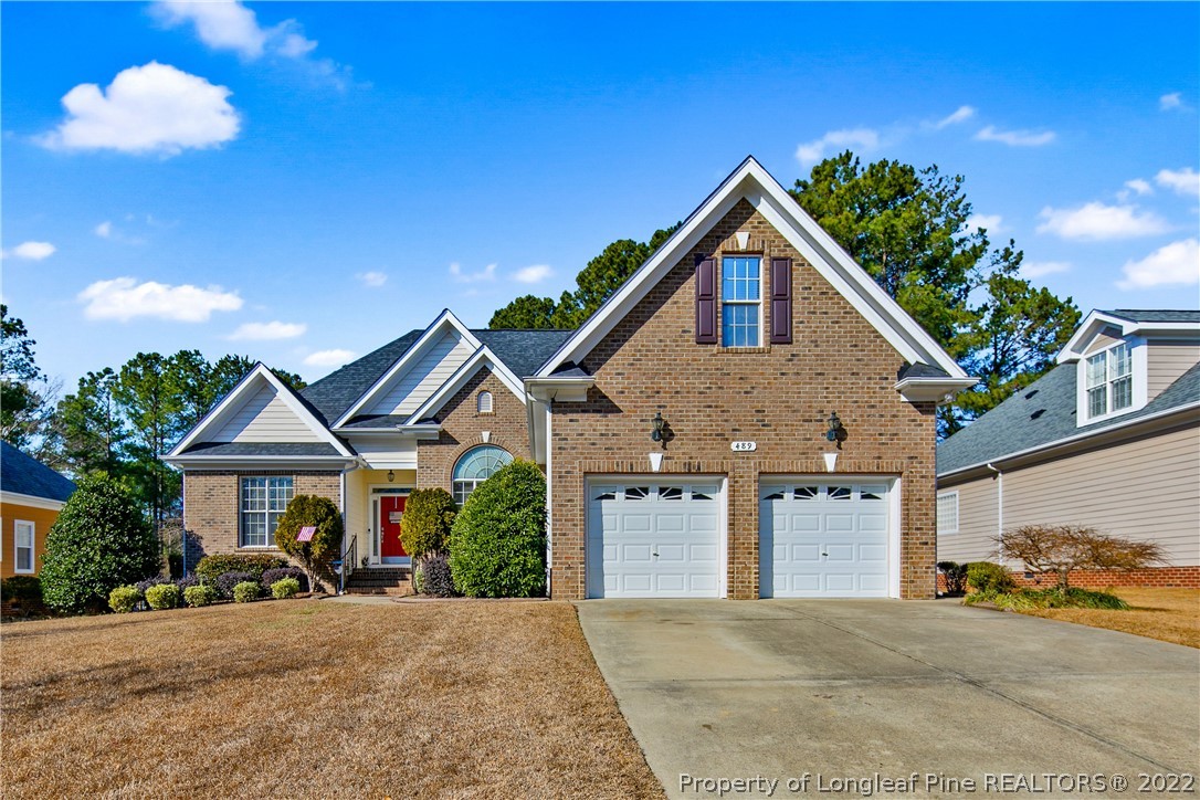 489 Falling Water Road Spring Lake, NC 28390 - Photo 1 of 50 a front view of a house with a yard and garage