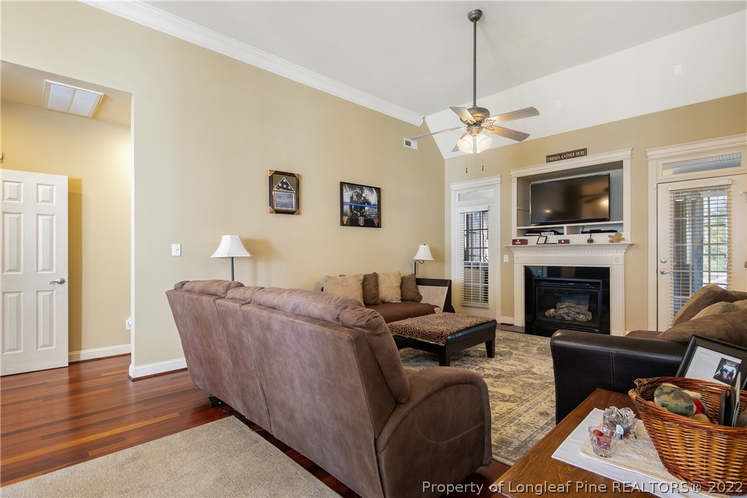 489 Falling Water Road Spring Lake, NC 28390 - Photo 15 of 50 a living room with furniture a fireplace and a flat screen tv