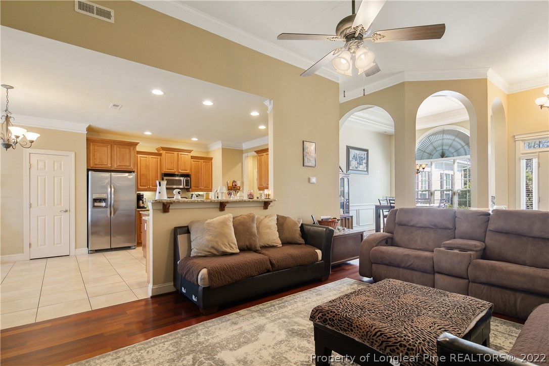 489 Falling Water Road Spring Lake, NC 28390 - Photo 16 of 50 a living room with furniture kitchen view and a chandelier