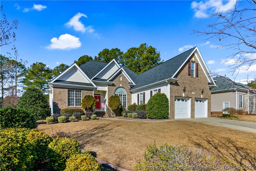 489 Falling Water Road Spring Lake, NC 28390 - Photo 2 of 50 a front view of a house with a yard and potted plants