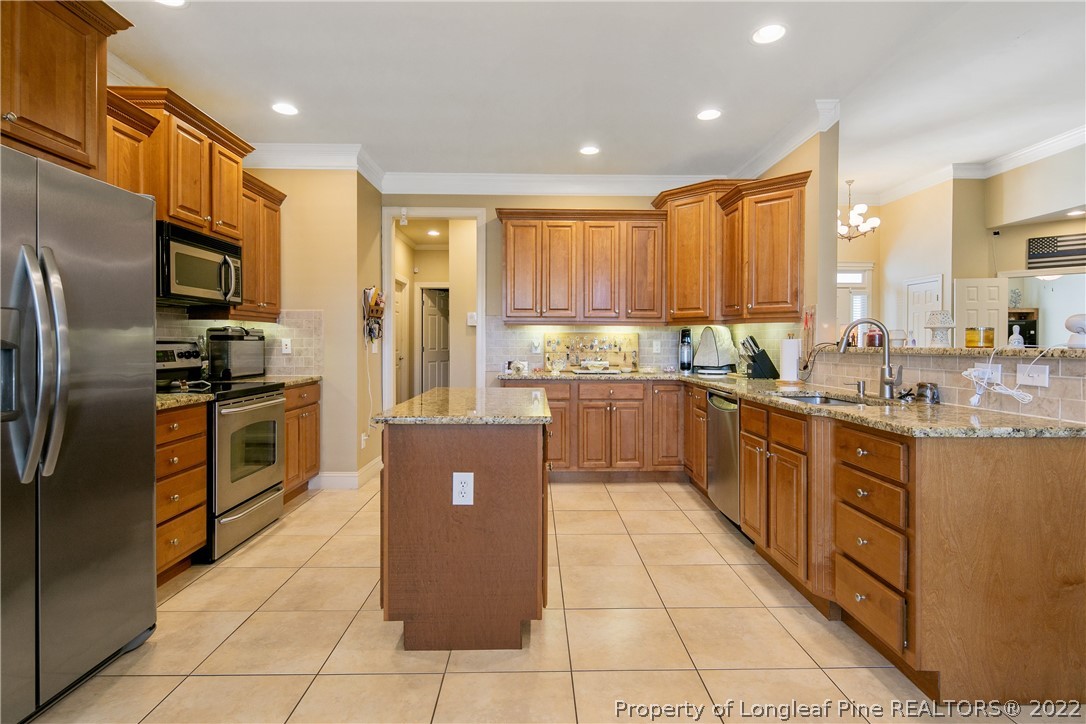 489 Falling Water Road Spring Lake, NC 28390 - Photo 22 of 50 a kitchen with stainless steel appliances granite countertop a refrigerator a sink a stove top oven and a refrigerator