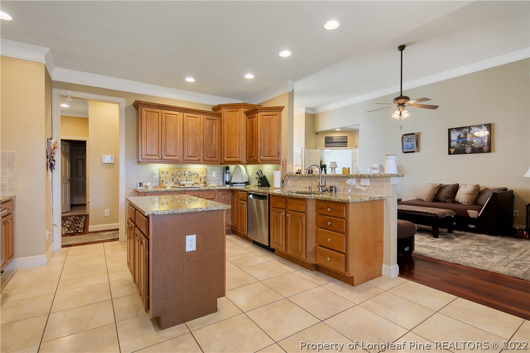 489 Falling Water Road Spring Lake, NC 28390 - Photo 23 of 50 a kitchen with kitchen island granite countertop a stove and a sink