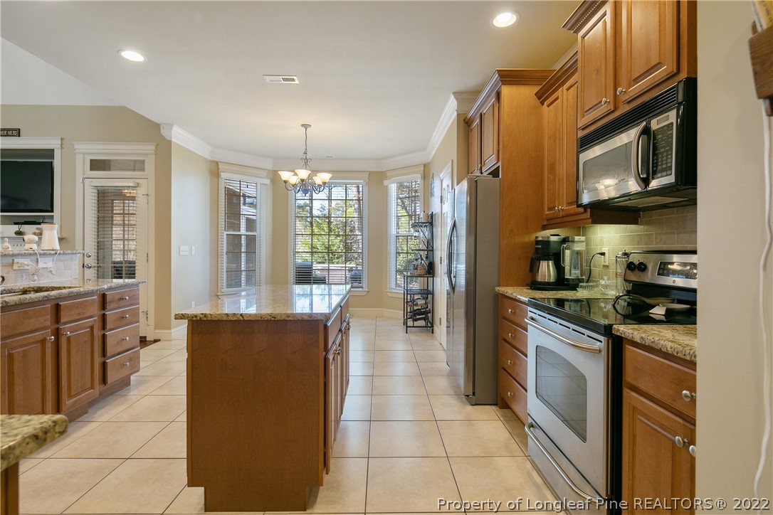 489 Falling Water Road Spring Lake, NC 28390 - Photo 25 of 50 a kitchen with stainless steel appliances granite countertop a refrigerator a stove top oven a sink and dishwasher