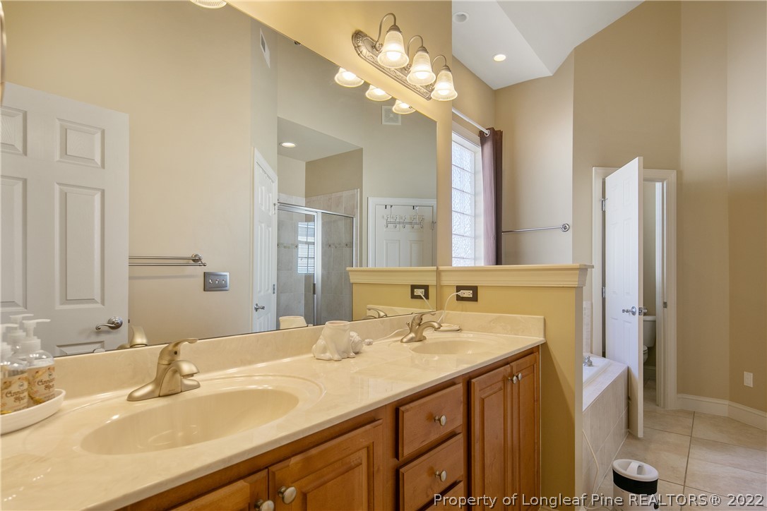 489 Falling Water Road Spring Lake, NC 28390 - Photo 34 of 50 a bathroom with a sink double vanity and a mirror
