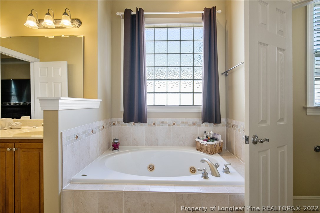 489 Falling Water Road Spring Lake, NC 28390 - Photo 36 of 50 a bathroom with a bathtub and a window