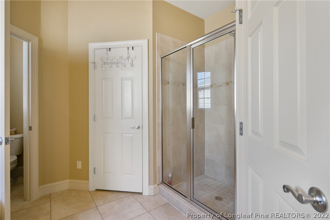 489 Falling Water Road Spring Lake, NC 28390 - Photo 38 of 50 a bathroom with a shower and a glass door