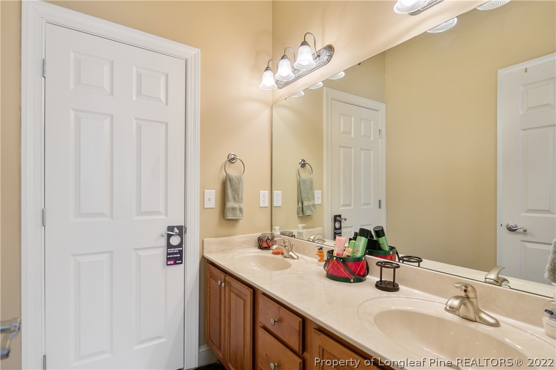 489 Falling Water Road Spring Lake, NC 28390 - Photo 42 of 50 a bathroom with a double vanity sink and a mirror