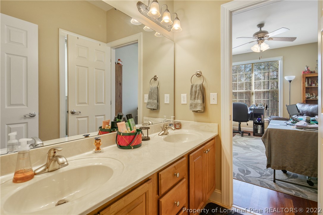 489 Falling Water Road Spring Lake, NC 28390 - Photo 43 of 50 a bathroom with double vanity sinks a vanity and a mirror