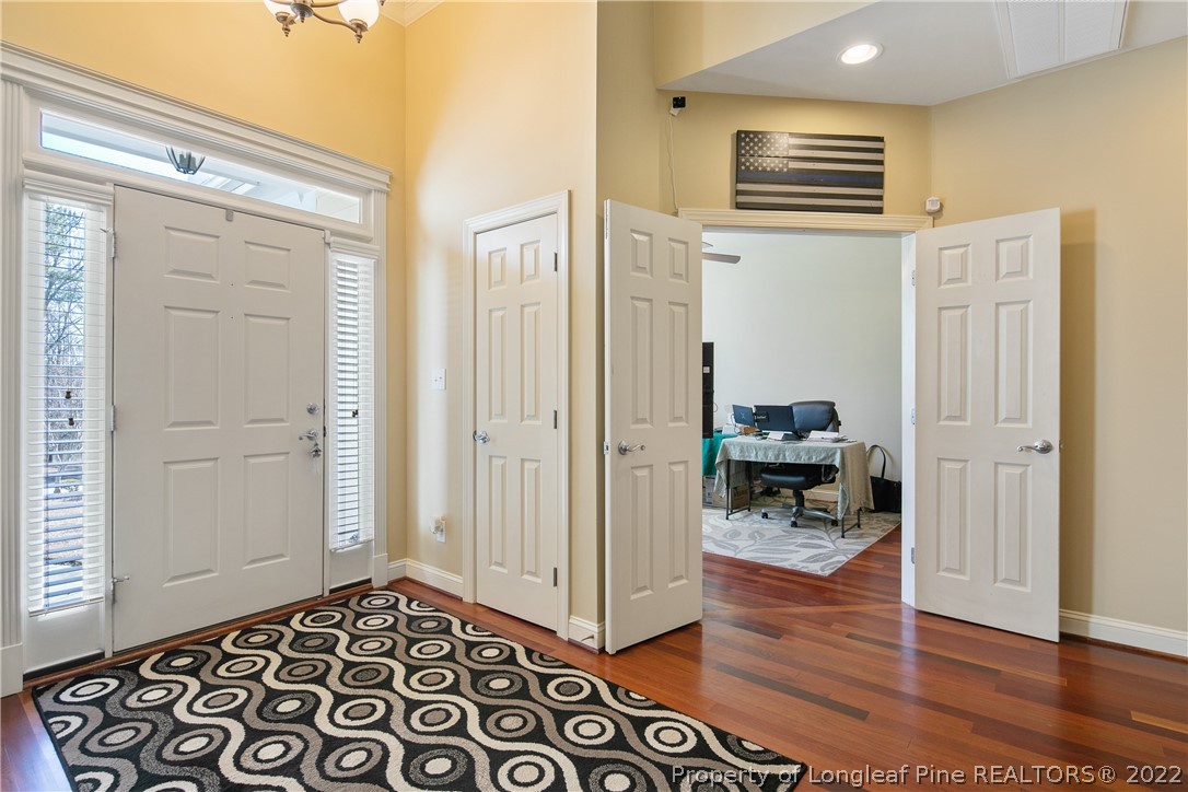 489 Falling Water Road Spring Lake, NC 28390 - Photo 7 of 50 a view of a hallway and wooden floor and a livingroom with furniture