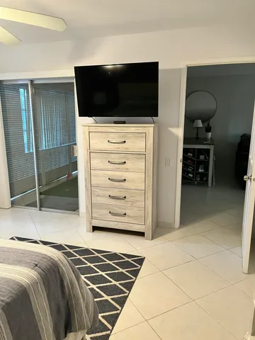 a bedroom with a bed and a flat screen tv
