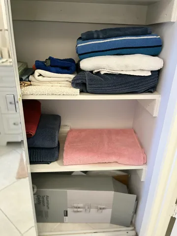 a white toilet next to a bathroom