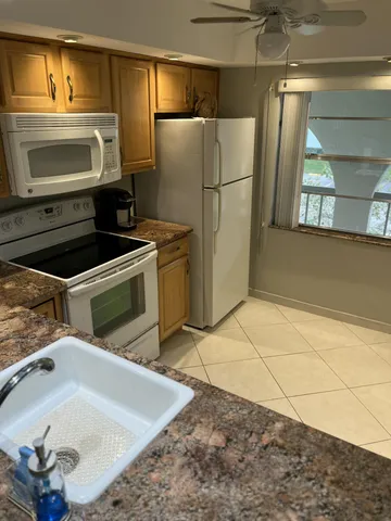 a kitchen with a sink stainless steel appliances and cabinets