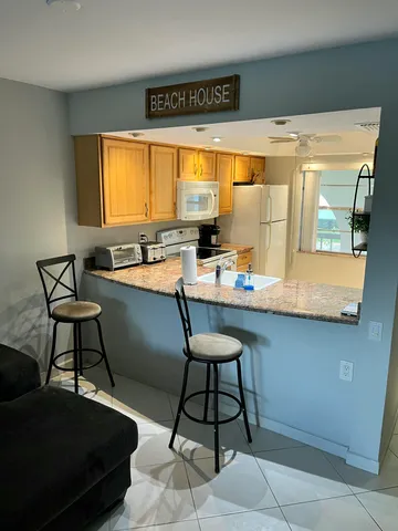 a room with table chairs and a flat screen tv