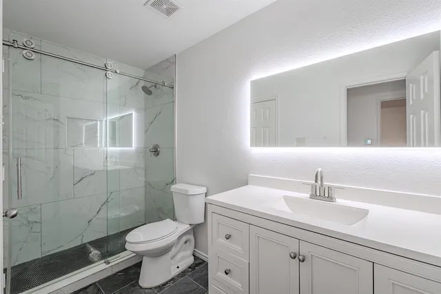 a bathroom with a sink toilet and shower