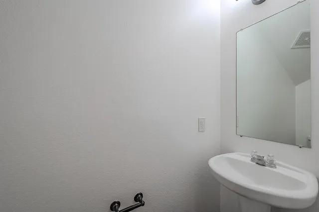 a bathroom with a sink and mirror