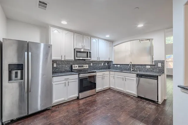 a kitchen with a sink stove and refrigerator