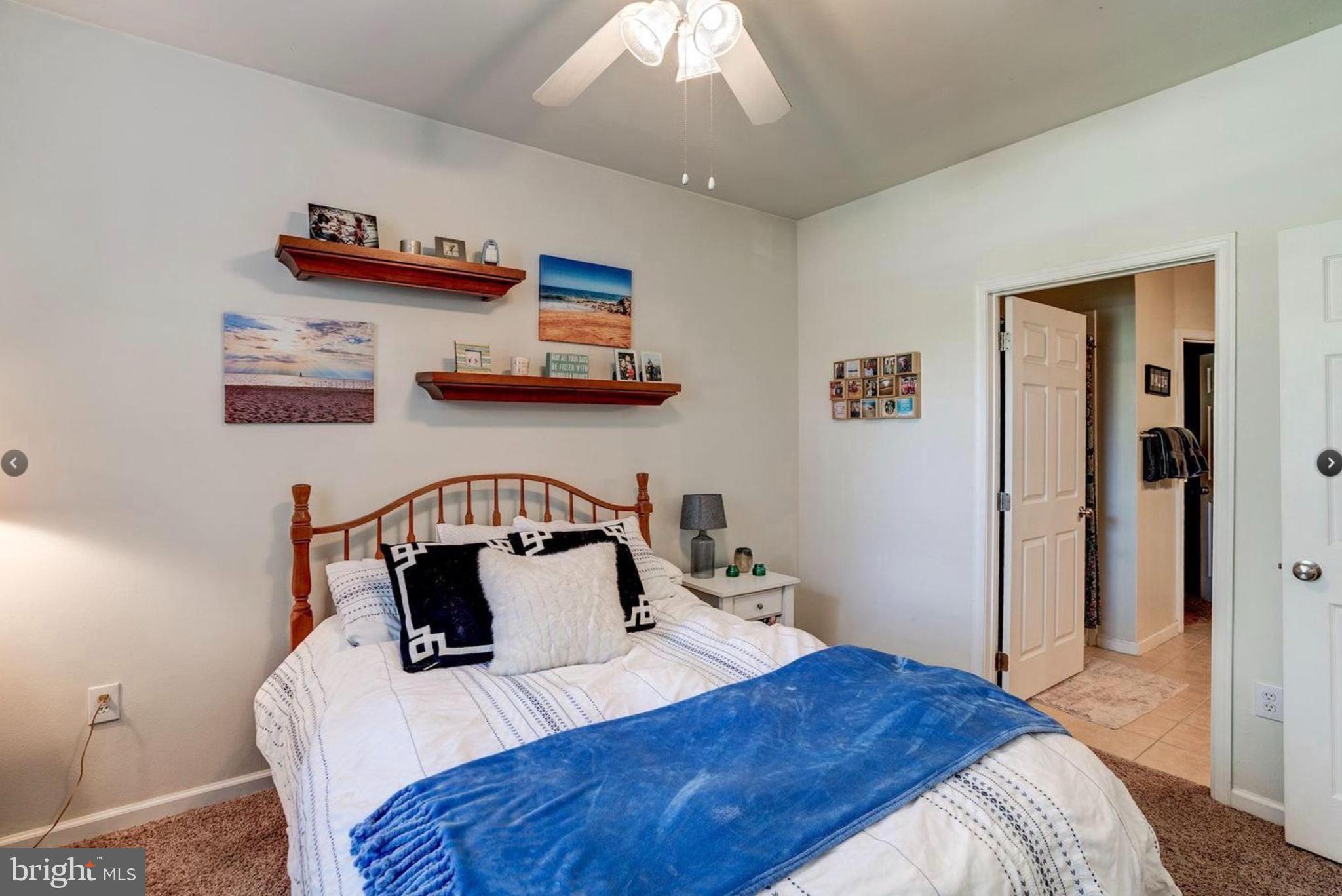 12957 Centre Park Circle, Unit 112 Herndon, VA 20171 - Photo 11 of 25 a bedroom with a bed and wooden floor